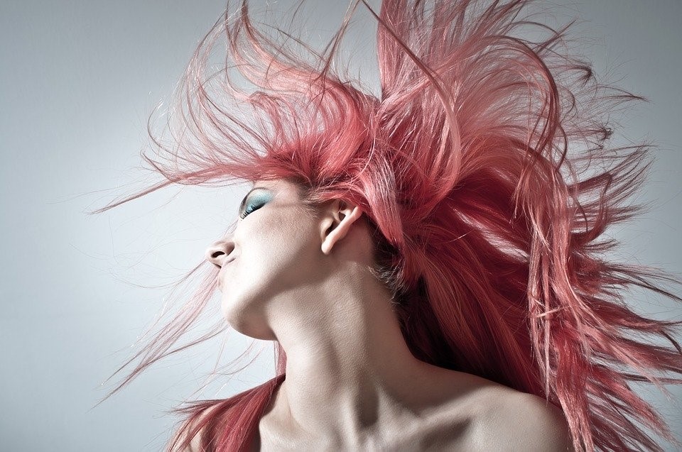A woman feeling bold and confident after getting a new haircut and color treatment