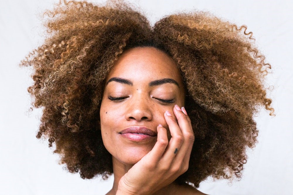 A woman touching her face